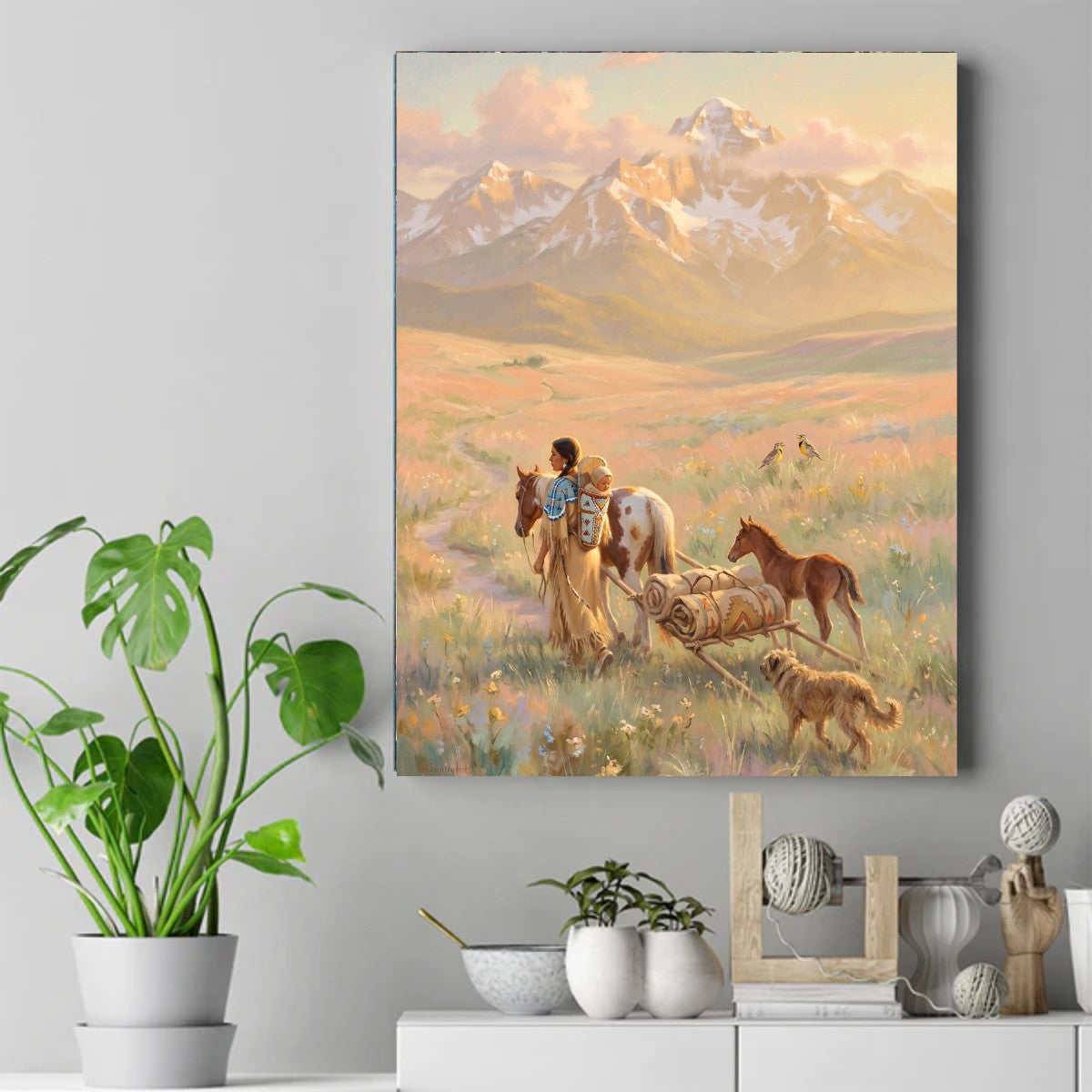 Native woman with a baby in a cradleboard leading a horse and travois with a foal and dog in a mountain meadow. – ảnh 2