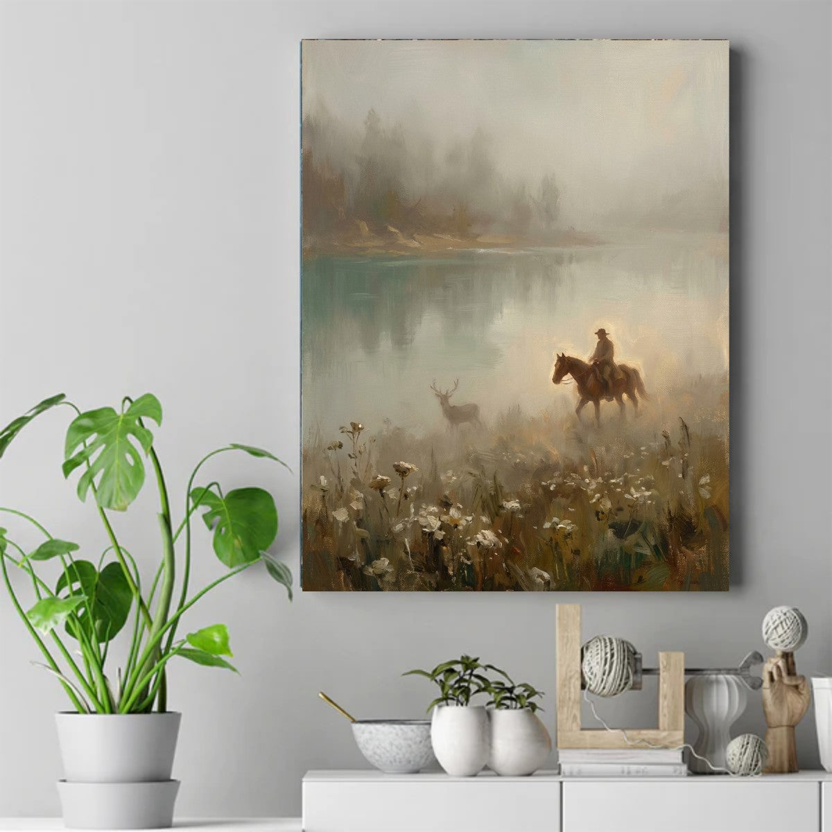 Native rider on horseback and a deer standing in mist beside a calm lake, with white wildflowers in the foreground – ảnh 2
