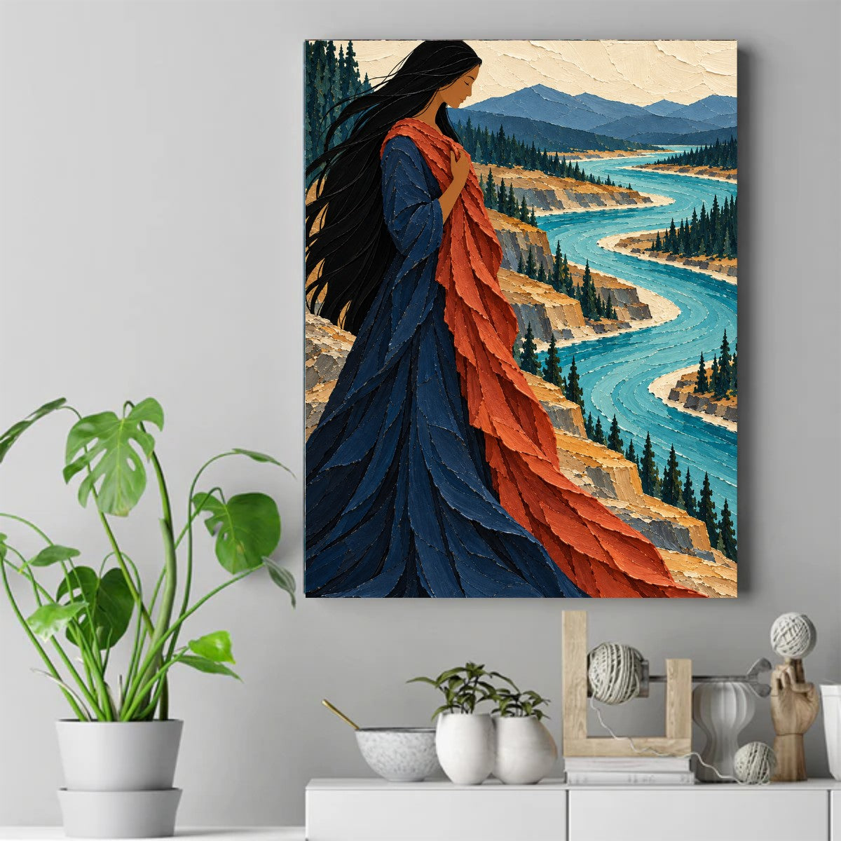 Native woman in a blue dress holding an orange shawl by a winding turquoise river with mountains and pine trees. – ảnh 2