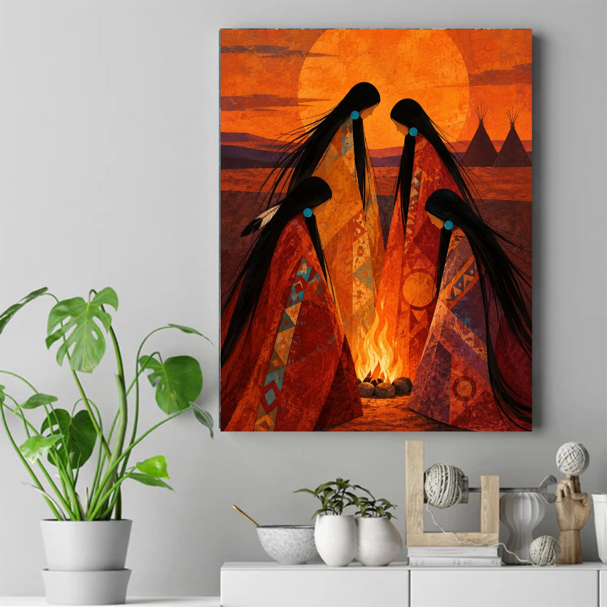 Four Native women in patterned blankets circle a small fire under a huge orange sun, tipis in the distance. – ảnh 2