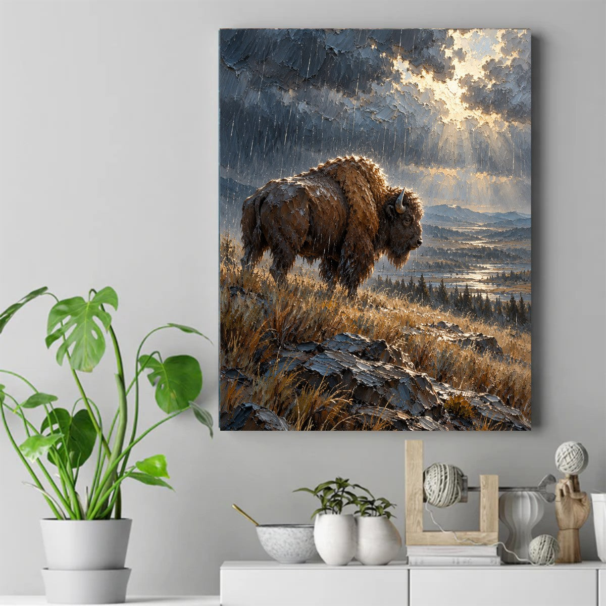 A shaggy bison stands in the rain on a rocky grassy hill as sunbeams break through dark storm clouds over a distant valley. – ảnh 2