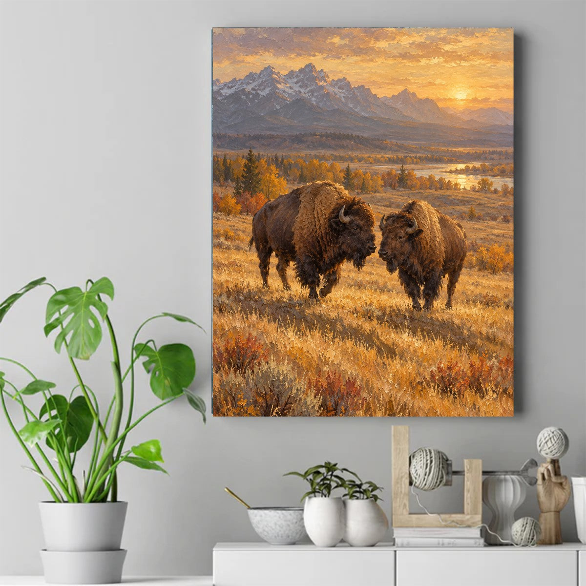 Two bison facing each other in golden autumn grass with mountains and sunset behind them – ảnh 2