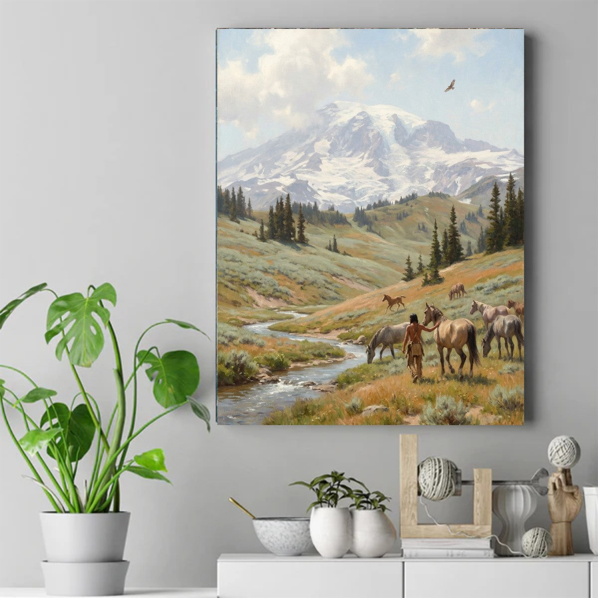 Native figure standing beside horses in a green valley with a stream, pine trees, a snow-capped mountain and a flying eagle. – ảnh 2
