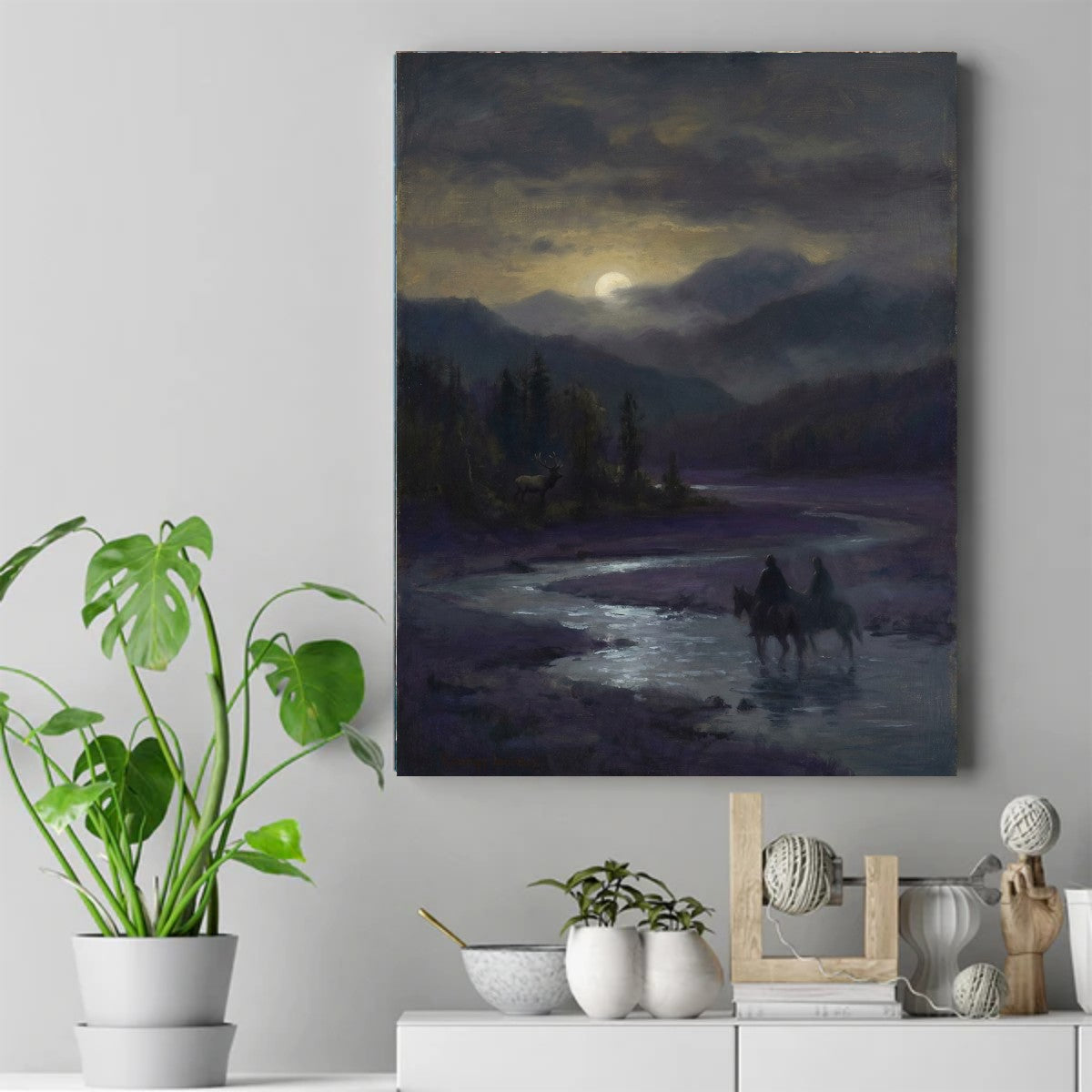 Two riders on horseback wading across a moonlit river at night, with a stag standing among pines on the bank – ảnh 2