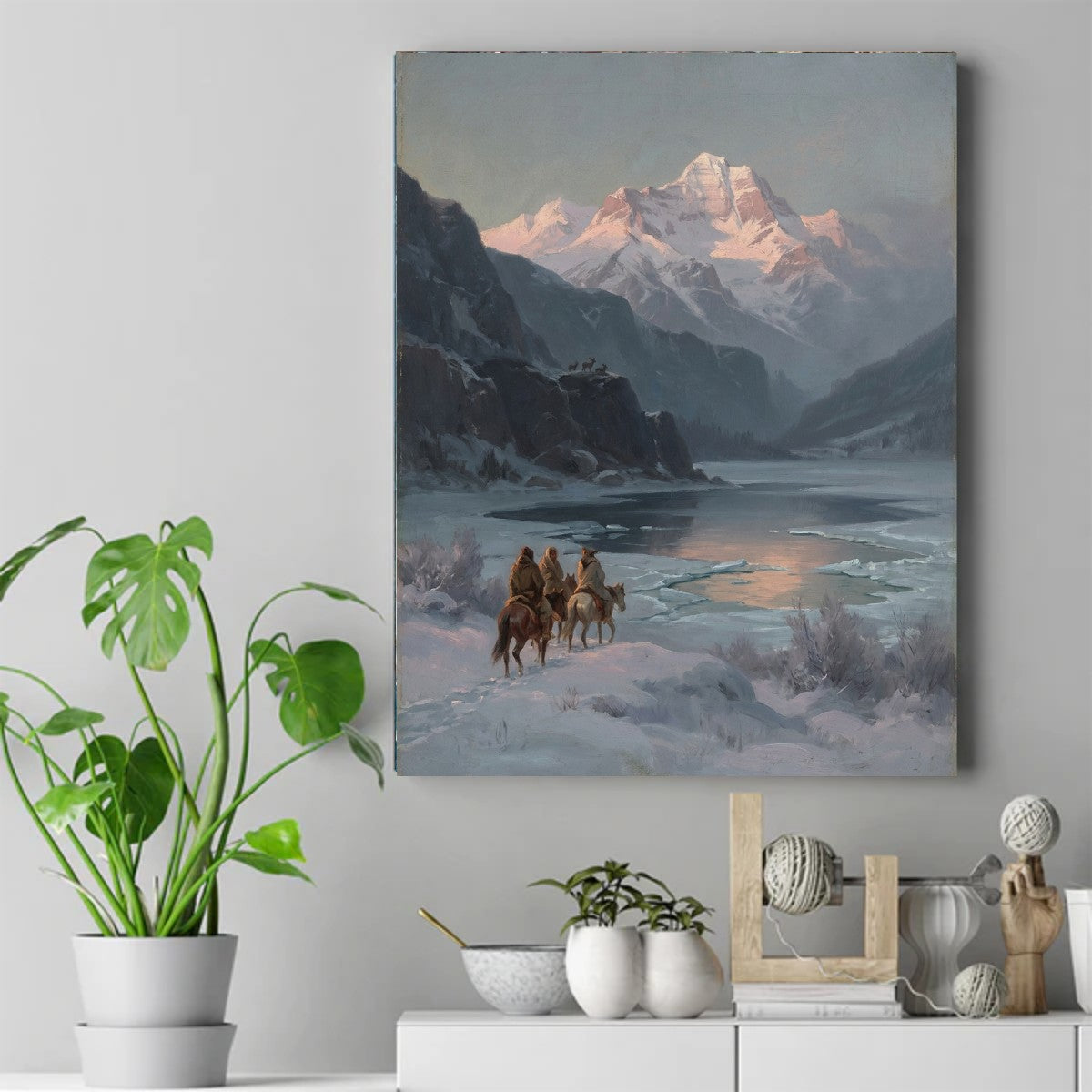 Three Native riders on horseback in a snowy valley, with a rose-lit mountain peak and icy lake in the background. – ảnh 2