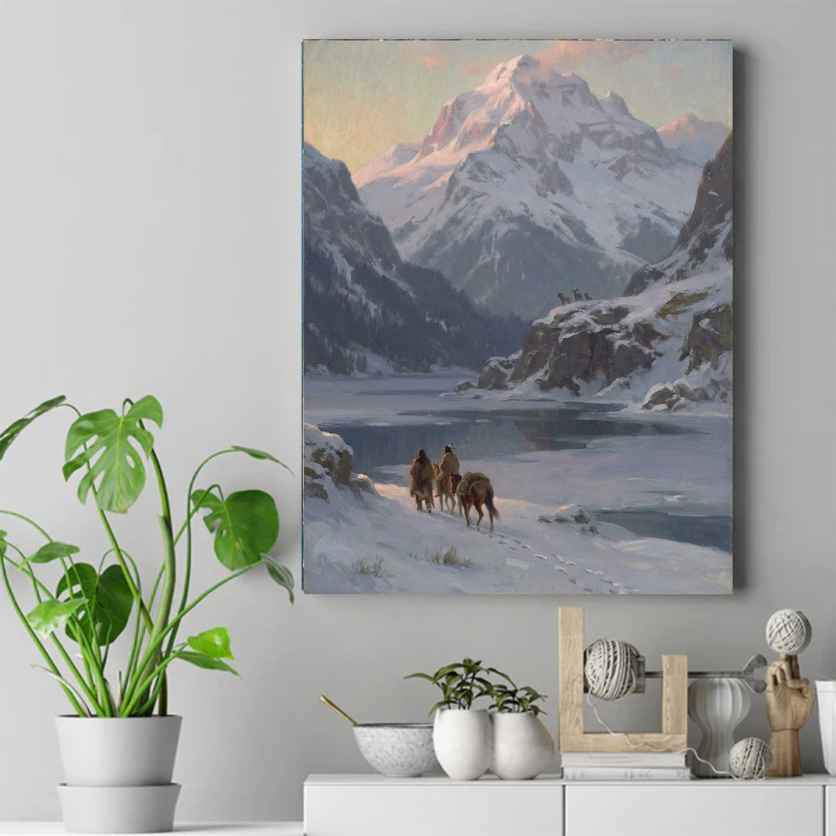 Native riders on horseback and pack horse walking along a snowy shore below a pink-lit mountain peak. – ảnh 2