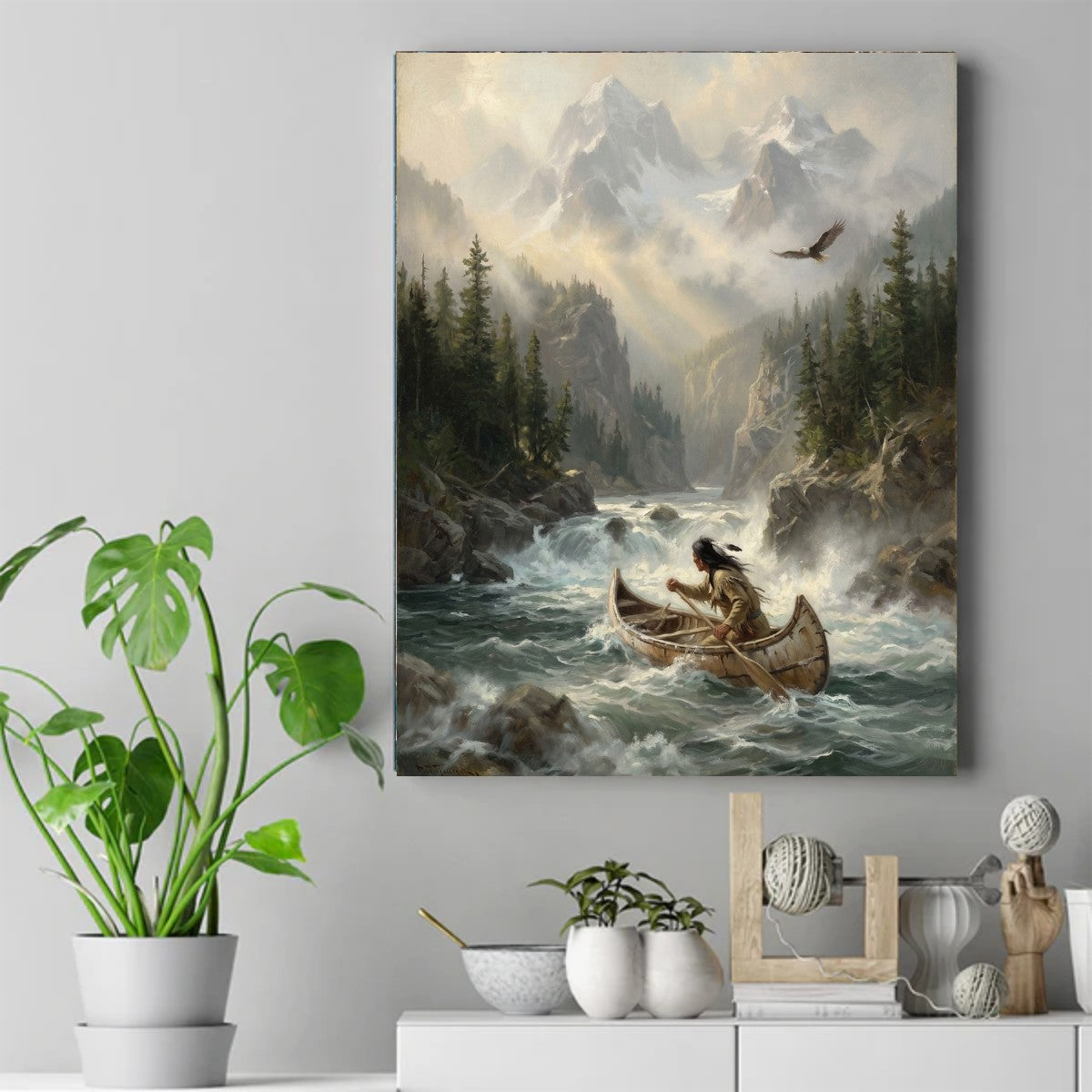 Native paddler in a birchbark canoe on rushing rapids below misty snow-capped mountains, with an eagle overhead. – ảnh 2
