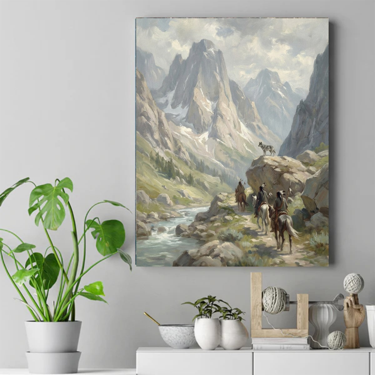 Painting of three Native riders on horseback in a mountain valley while a gray wolf stands on a rock watching them – ảnh 2