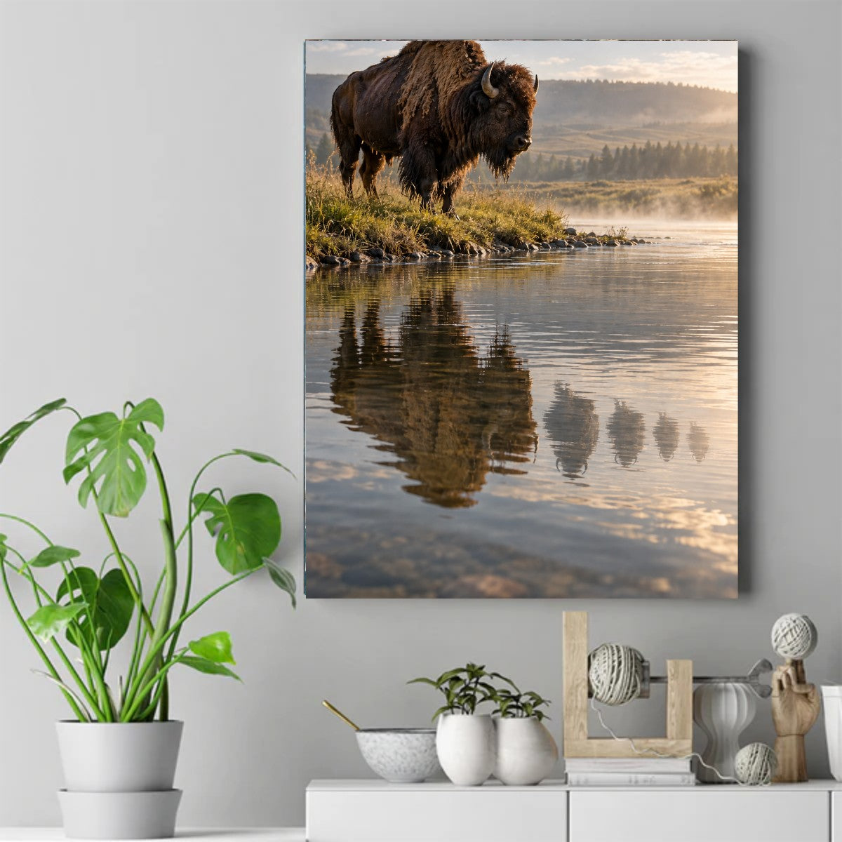 Bison standing on a grassy riverbank at sunrise with mist rising off the water and its reflection below – ảnh 2