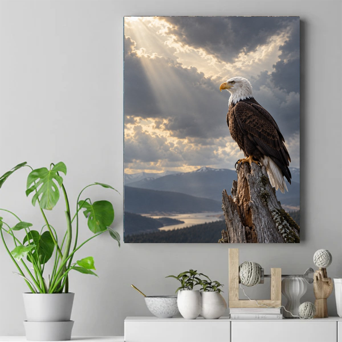 Bald eagle perched on a weathered stump as sunbeams break through clouds over misty mountains and a river valley – ảnh 2