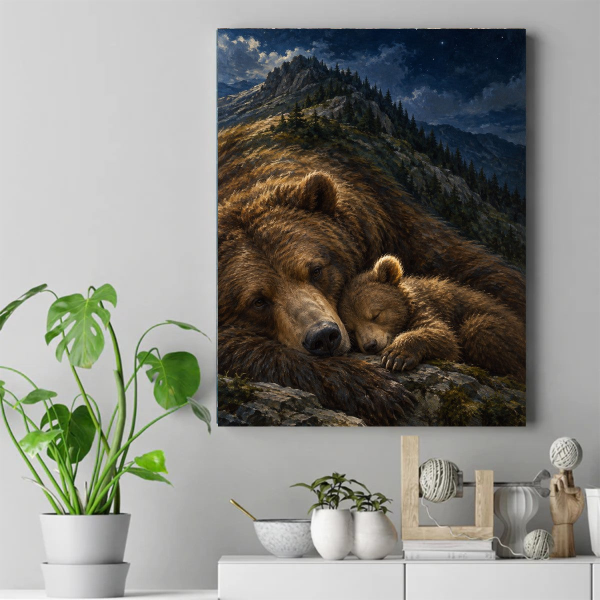 Large brown bear lying with a sleeping cub on rocky ground beneath a starry night sky and pine-covered mountain ridge. – ảnh 2