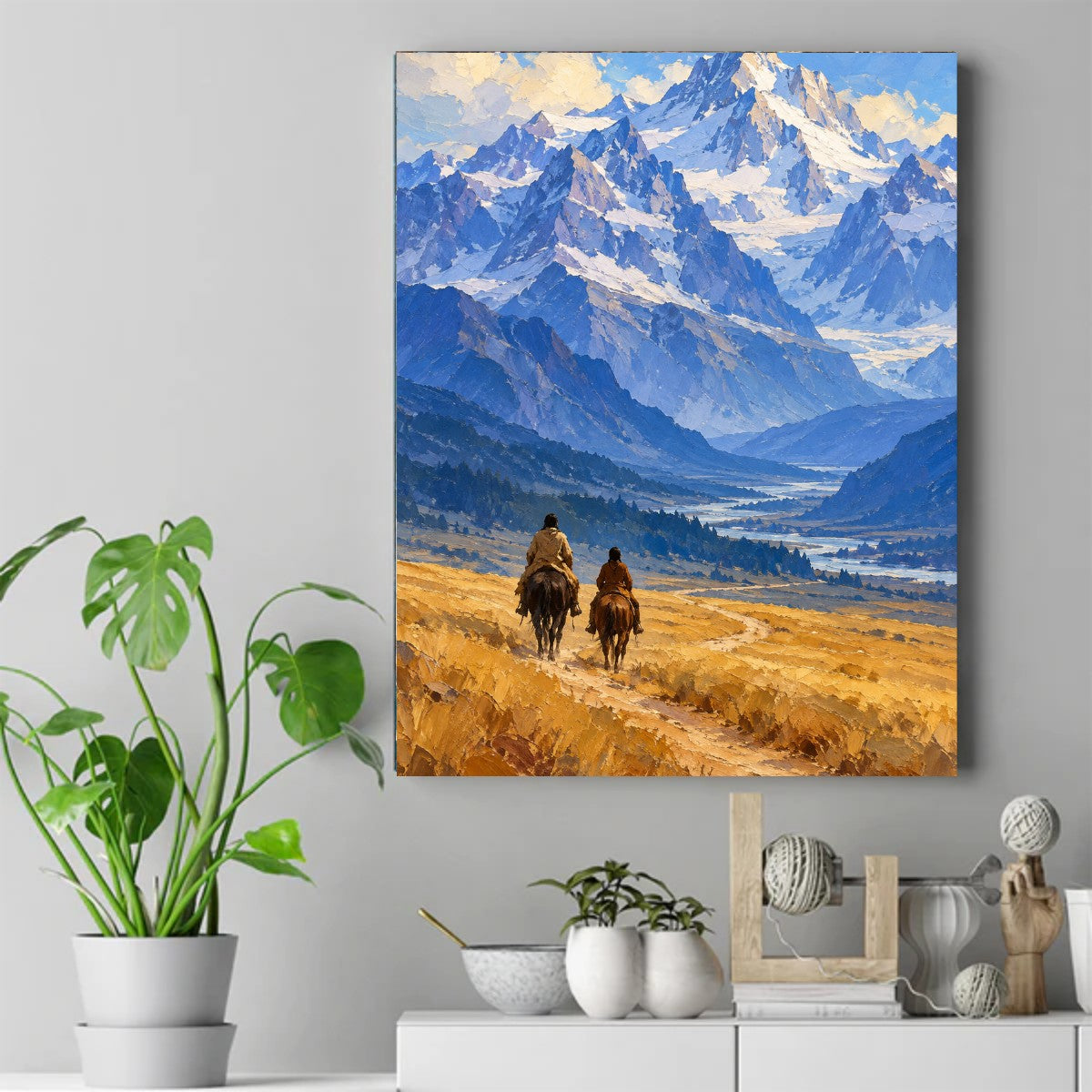 Two riders on horseback seen from behind on a golden trail leading toward blue snow-capped mountains – ảnh 2