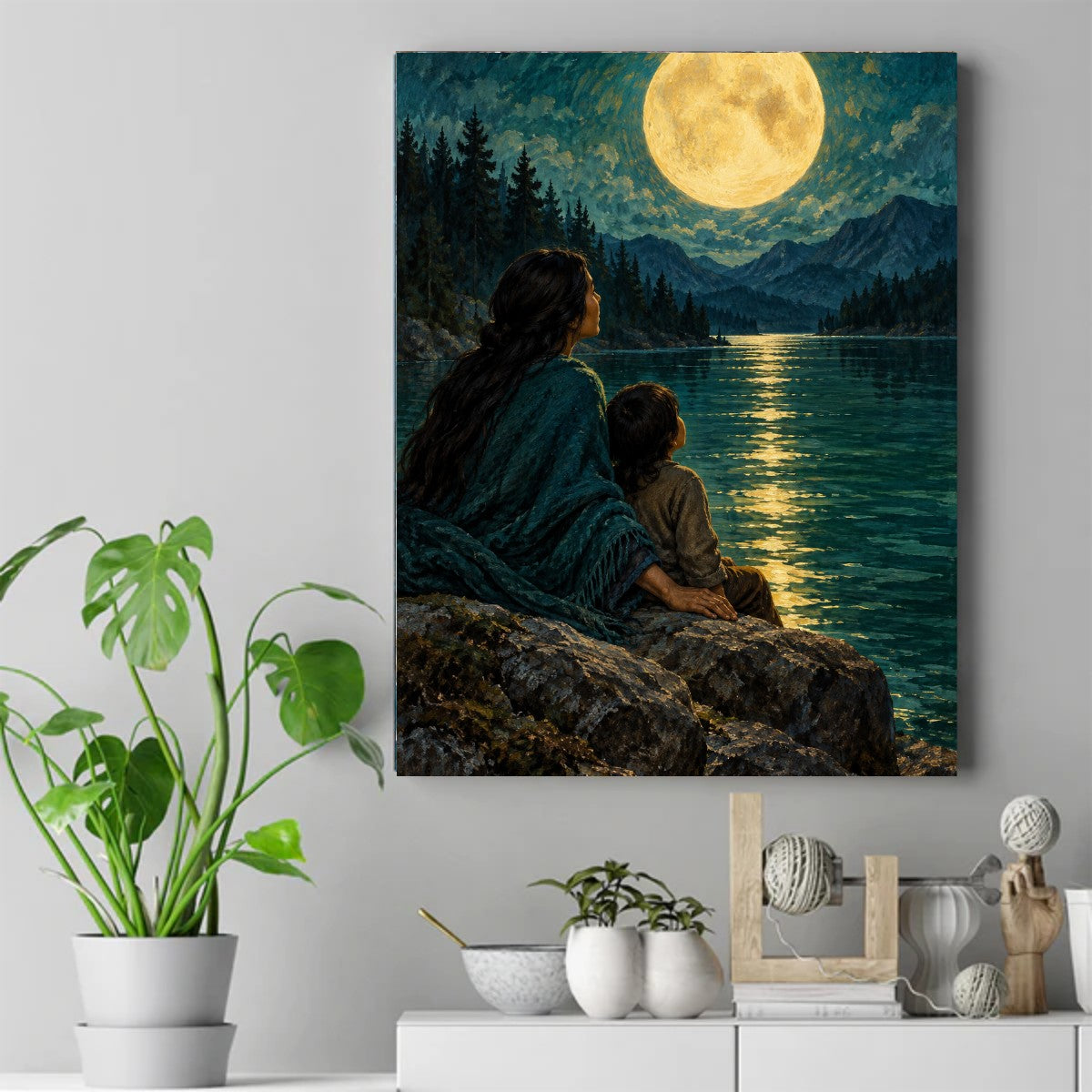Native woman and child on rocks by a lake at night, watching a full moon over pine trees and mountains – ảnh 2