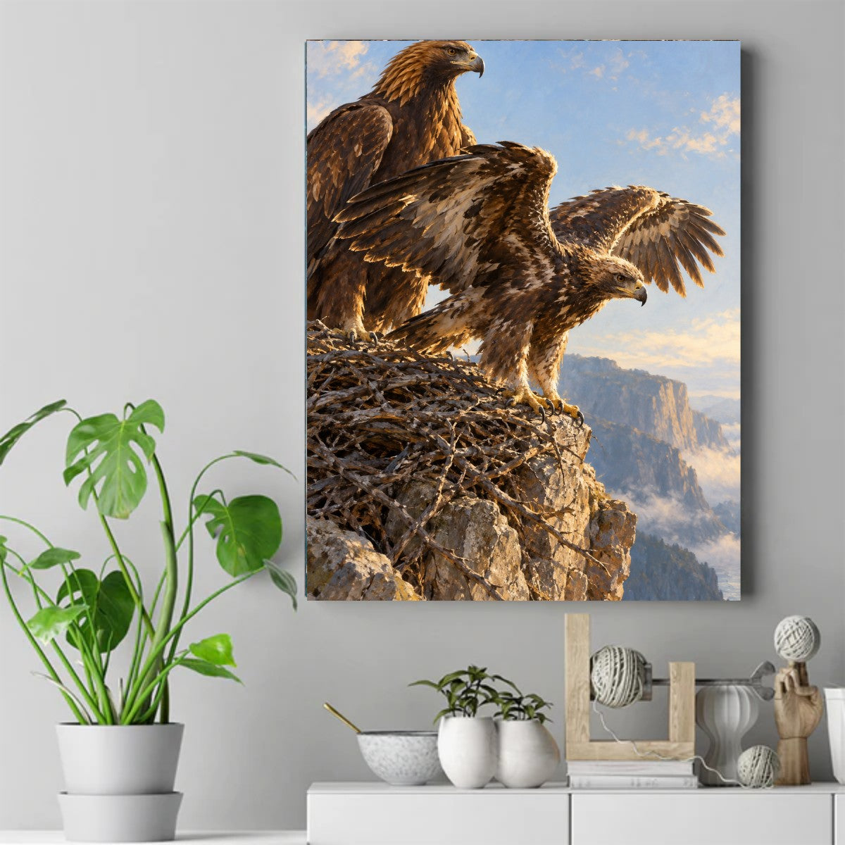 Two golden eagles on a stick nest atop a rocky cliff, one with wings spread wide, misty mountains behind – ảnh 2