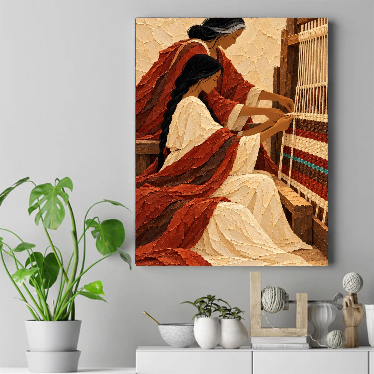 Older woman with gray hair gently guiding a younger woman's hands on a wooden loom with red, cream, and blue woven threads. – ảnh 2