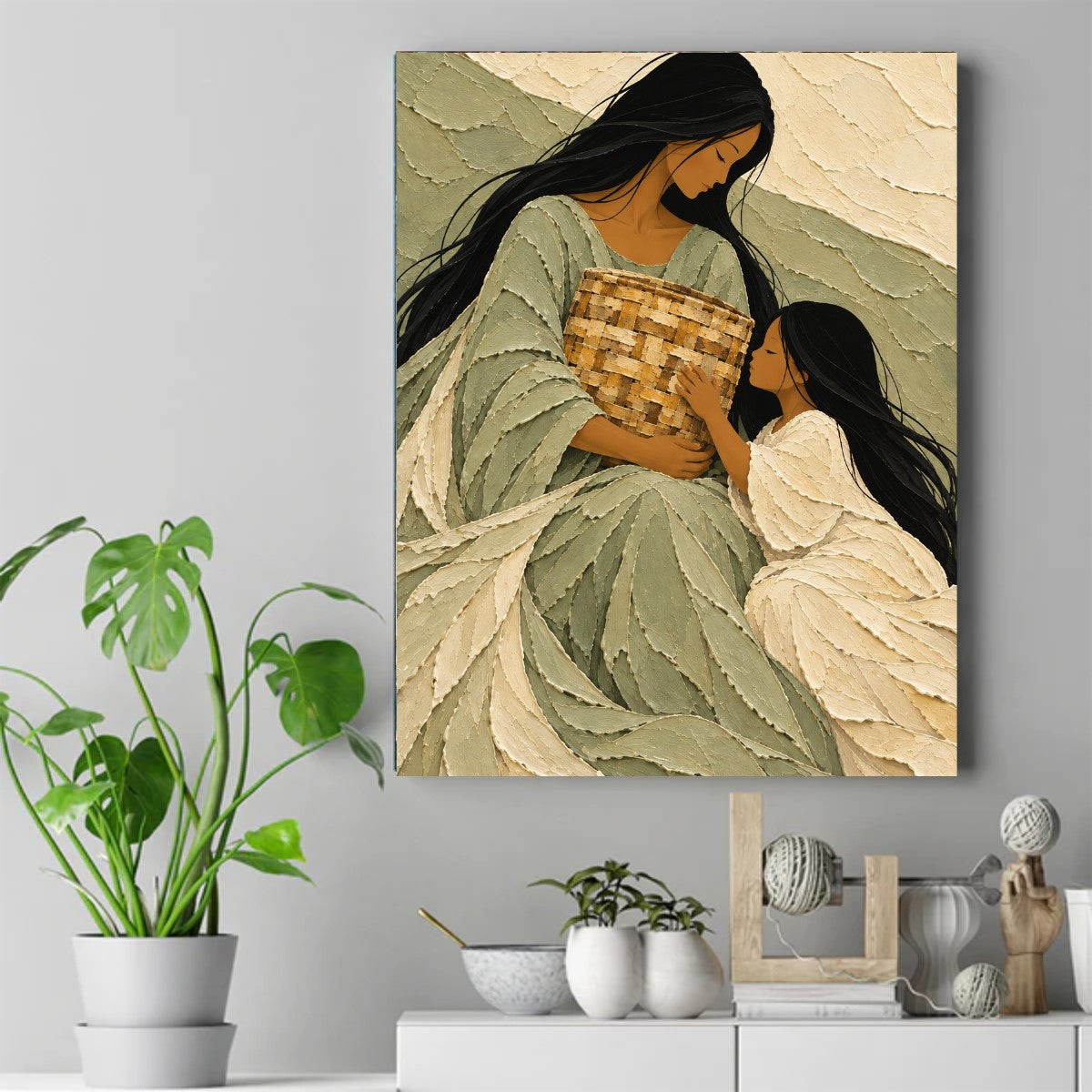 A mother and daughter in green and cream look down at a woven heirloom basket in a textured painting. – ảnh 2
