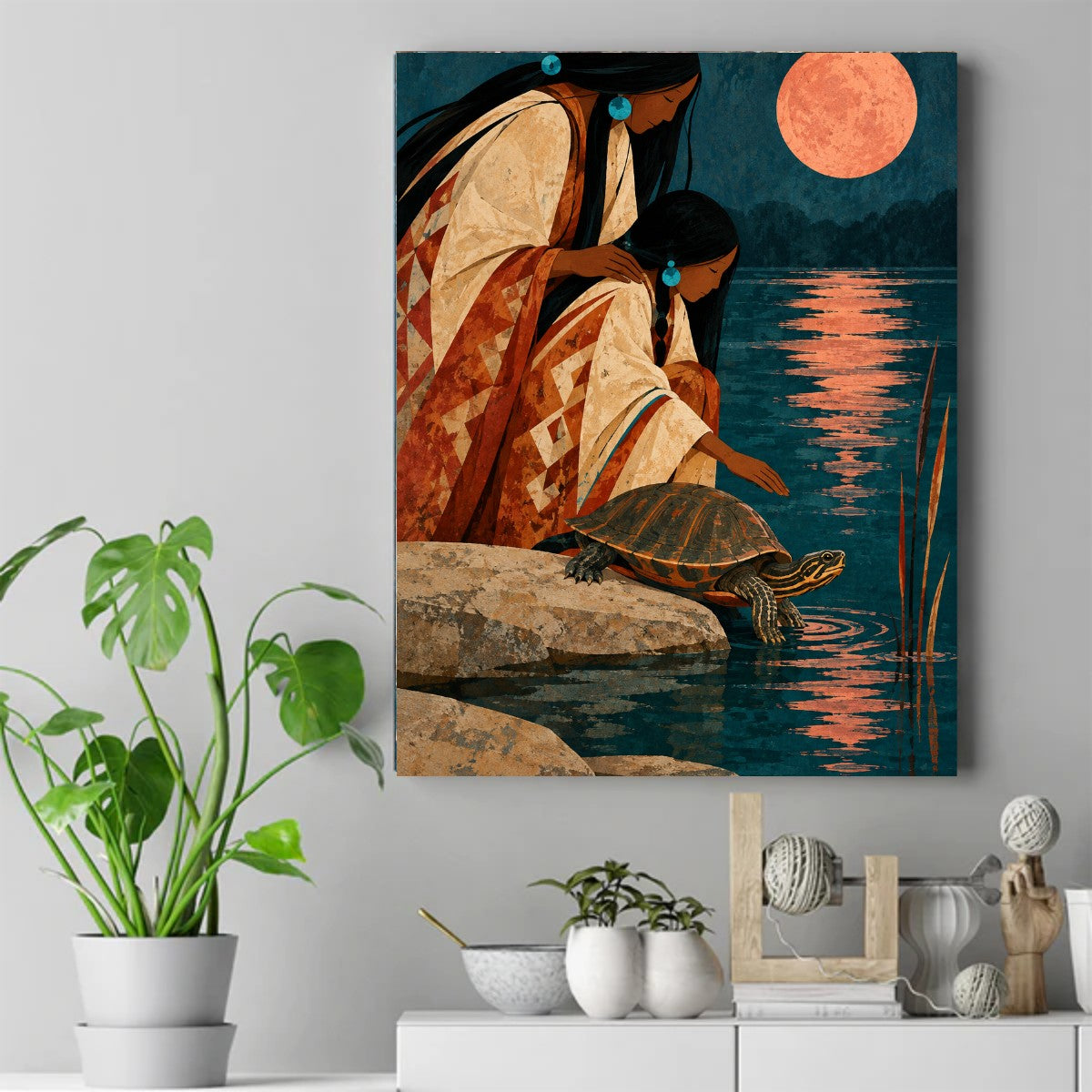 Two Native women kneel on rocks by dark water at night as a turtle climbs up, under a large salmon-colored moon. – ảnh 2