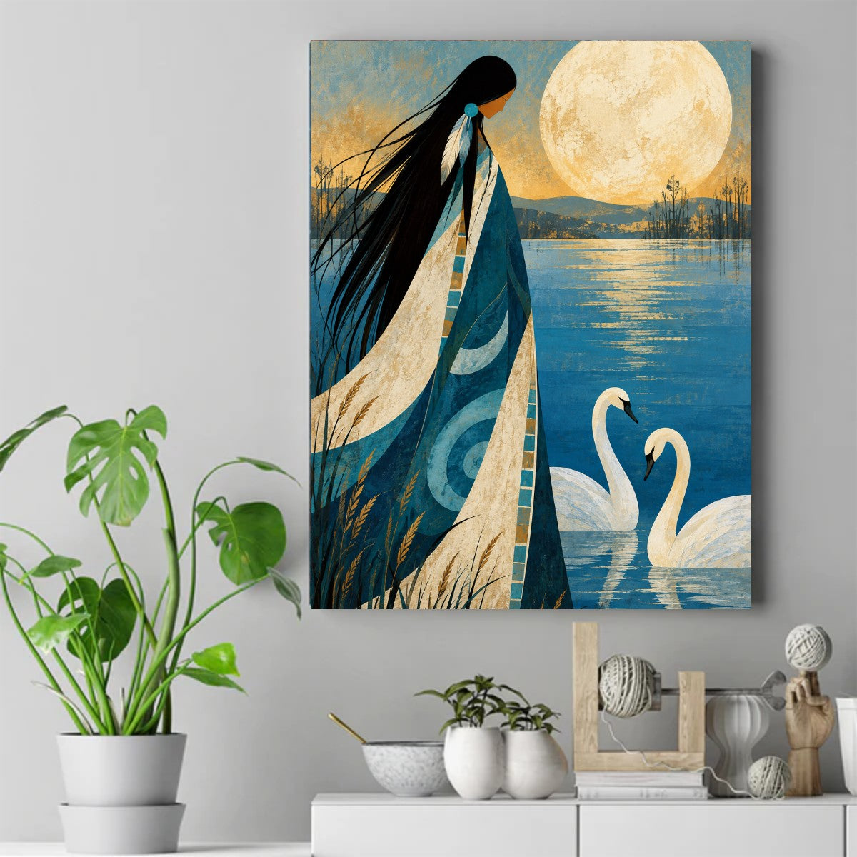 Native woman in a patterned blanket watching a full moon over a blue lake with two white swans – ảnh 2