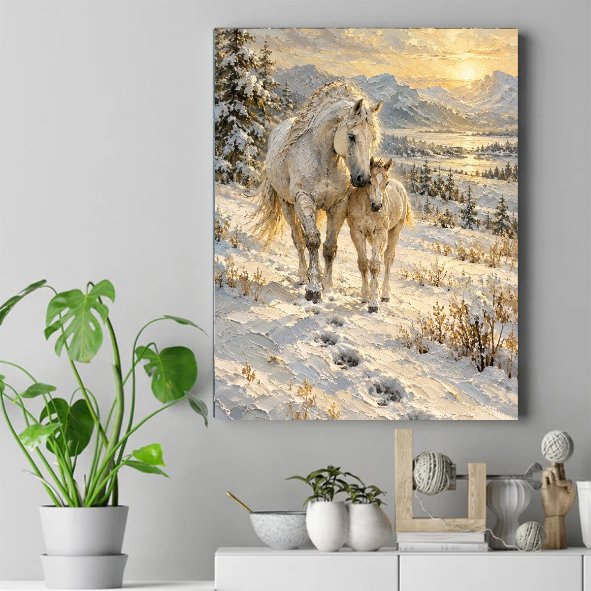 White mare and foal walking through snow with mountains, pine trees, and golden sunrise in the background – ảnh 2