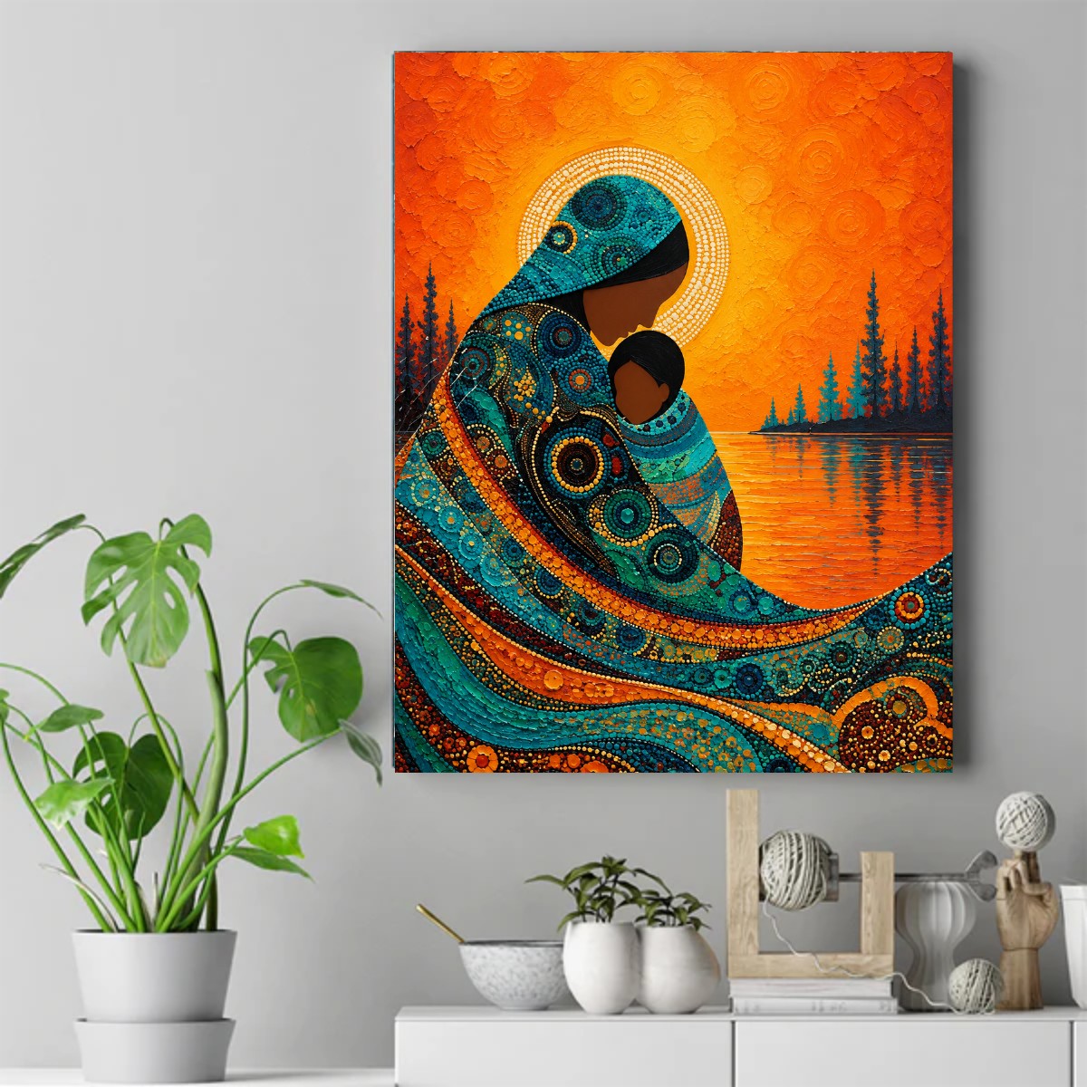 Native mother holding her child in a turquoise patterned blanket against an orange sunset, pine trees and water reflection. – ảnh 2