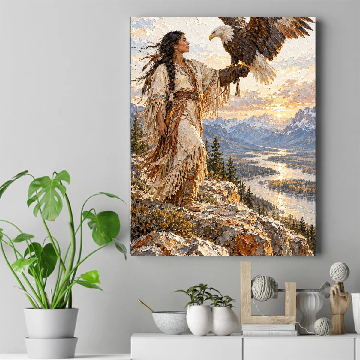 Native woman in fringed dress holding a bald eagle on her gloved hand above a river valley and snowy mountains at sunset – ảnh 2